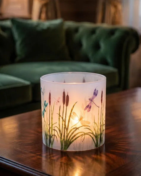 WaxHurricane lantern on a wooden table in a lounge