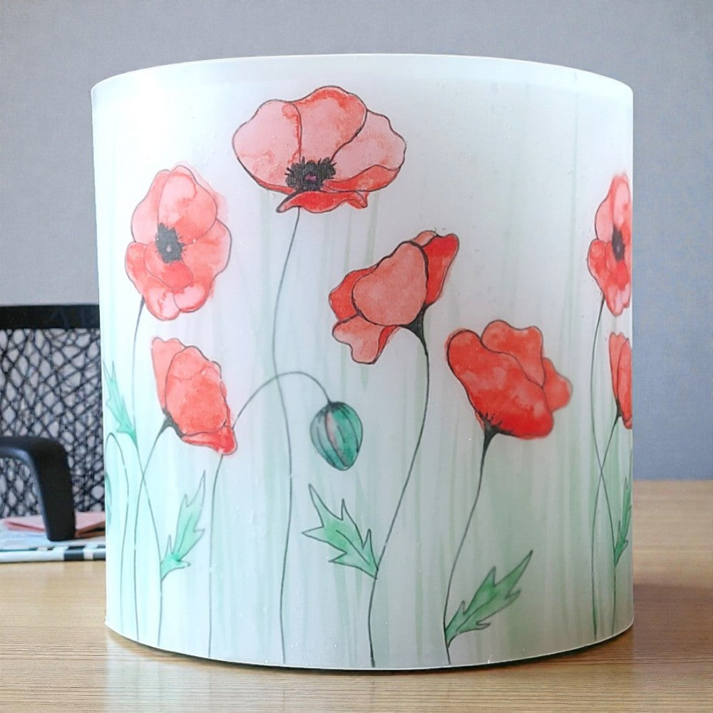 Wax Hurricane Lantern with red Poppy design on a wooden surface
