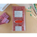  'On a Wick & Prayer' Original Wax bar -melt on a beige surface with matches . Blood Orange and Green Tea Fragrance