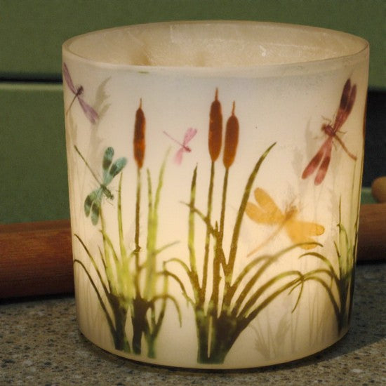 Decorative candle holder with nature-themed design featuring plants and dragonflies.