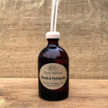 Bottle of Neroli & Petitgrain essential oil diffuser on a wooden surface