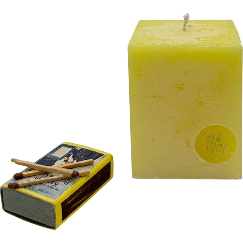 On a Wick and a Prayer yellow square pillar candle with a vintage matchbox. Hand-poured for clean burning and ambiance.