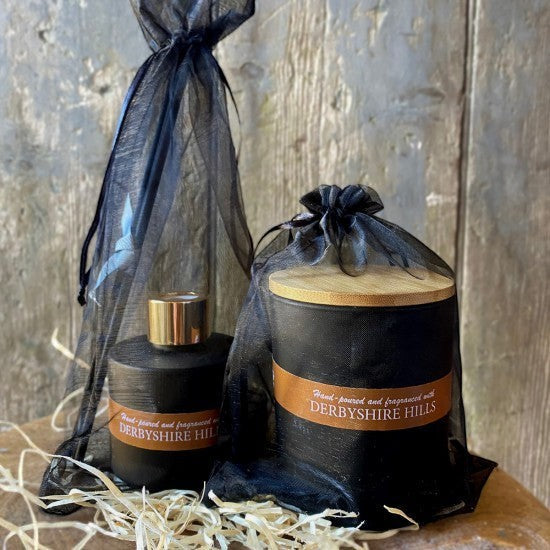 On a Wick and a Prayer Derbyshire Hills candle and diffuser set. Black vessels with bamboo lids, presented in black organza bags.