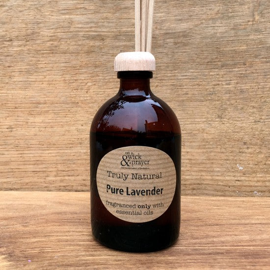 Brown bottle of 'Truly Natural Pure Lavender' on a wooden surface